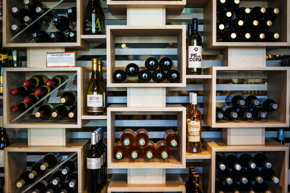 a wine collection in custom wooden cellar shelves, as featured in The Wine Movers’ blog on professional wine movers and moving a wine collection