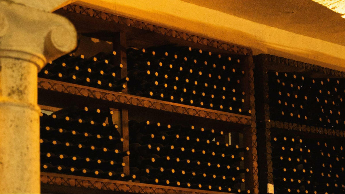 the wall of a wine cellar framed by an Ionic pillar, as shown in The Wine Mover’s blog post on wine moving services and wine shipping
