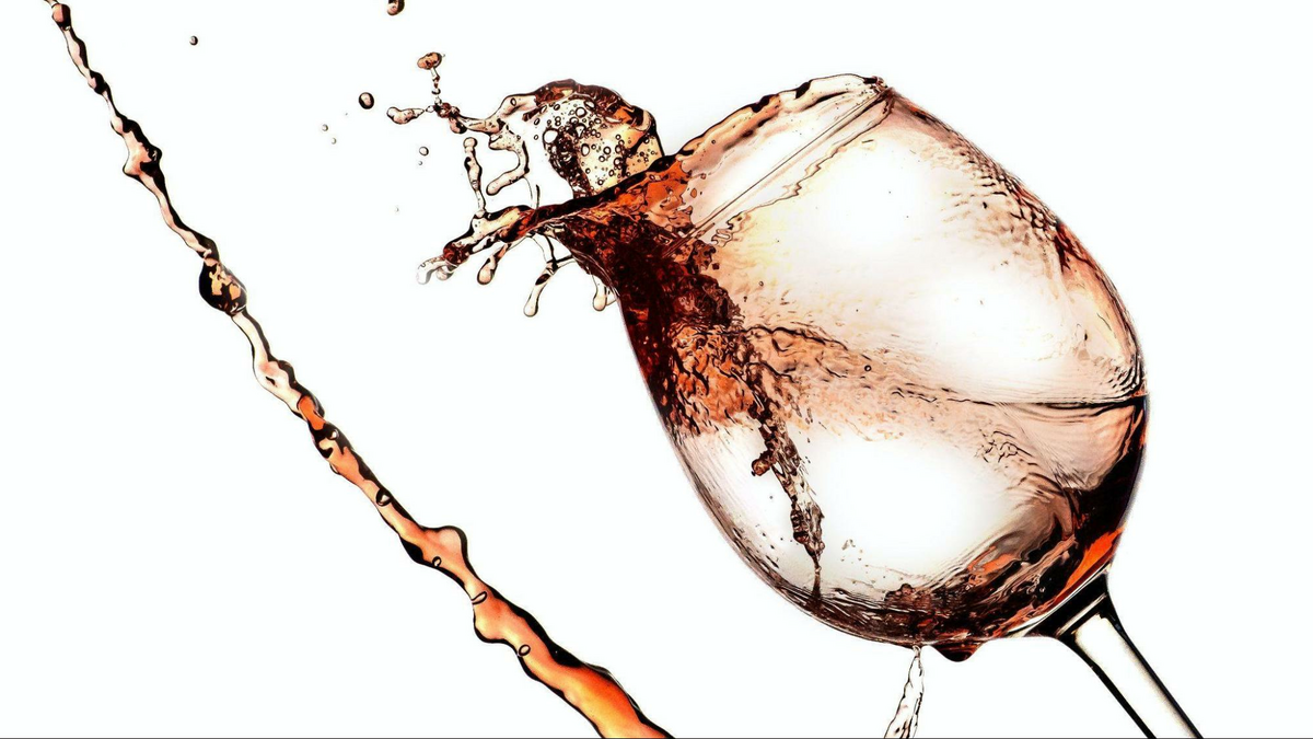 wine spilling out of a wine glass, as shown in The Wine Mover’s blog post on wine moving services and wine shipping